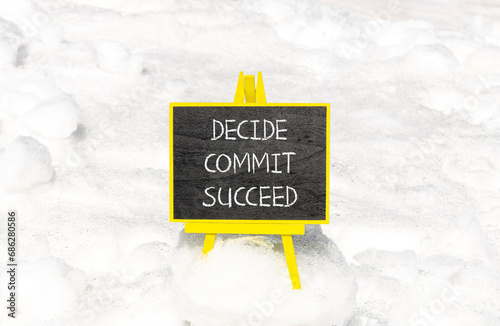 Decide commit succeed symbol. Concept word Decide Commit Succeed on beautiful black chalk blackboard. White snow. Beautiful white snow background. Business decide commit succeed concept. Copy space.