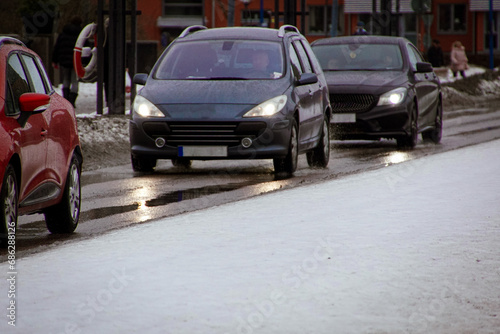 View of cars driving on city street at winter