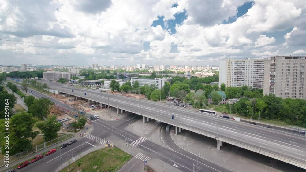 Top view from above of traffic on the elevated avenue road aerial timelapse overpass on Yaroslavl highway in Moscow, Russia. Construction site under the bridge Top view from above of traffic on the elevated avenue road aerial timelapse overpass on Yaroslavl highway in Moscow, Russia. Construction site under the bridge