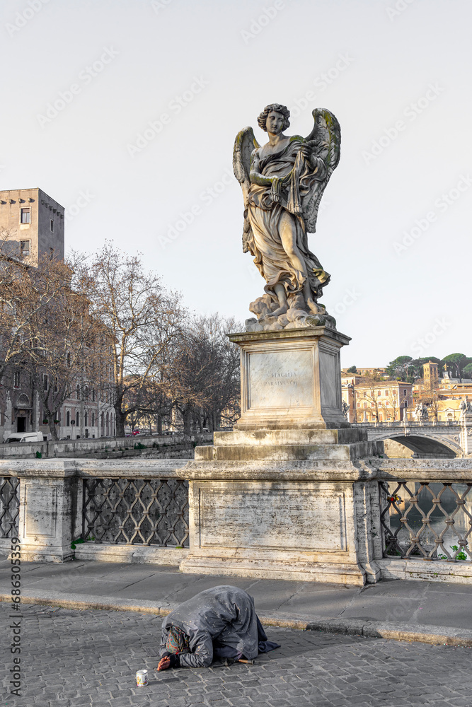 bridge of sant angelo over the river Tiber towards the castle of the same name, beggar begging for alms, city of rome