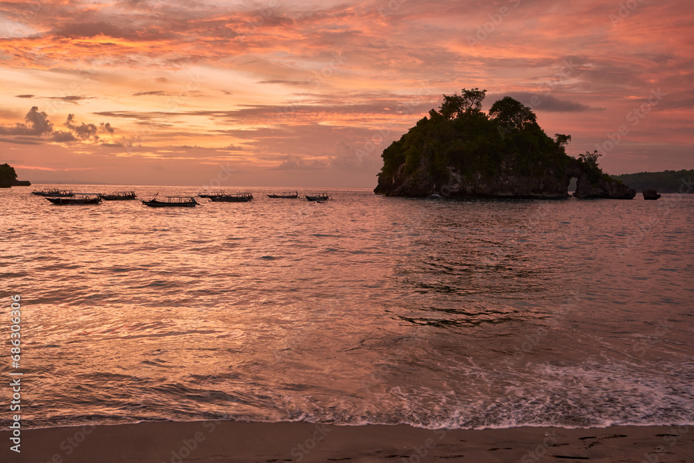 sunset on the sea at crystal bay in nusa penida