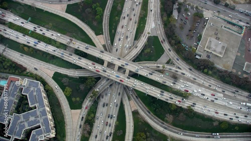 Overhead Aerial View of Traffic in Interstate 110 and 10 Highway Full of Cars and Trucks. Transportation. Famous Freeway interchange in Downtown Los Angeles, California. United States.  photo