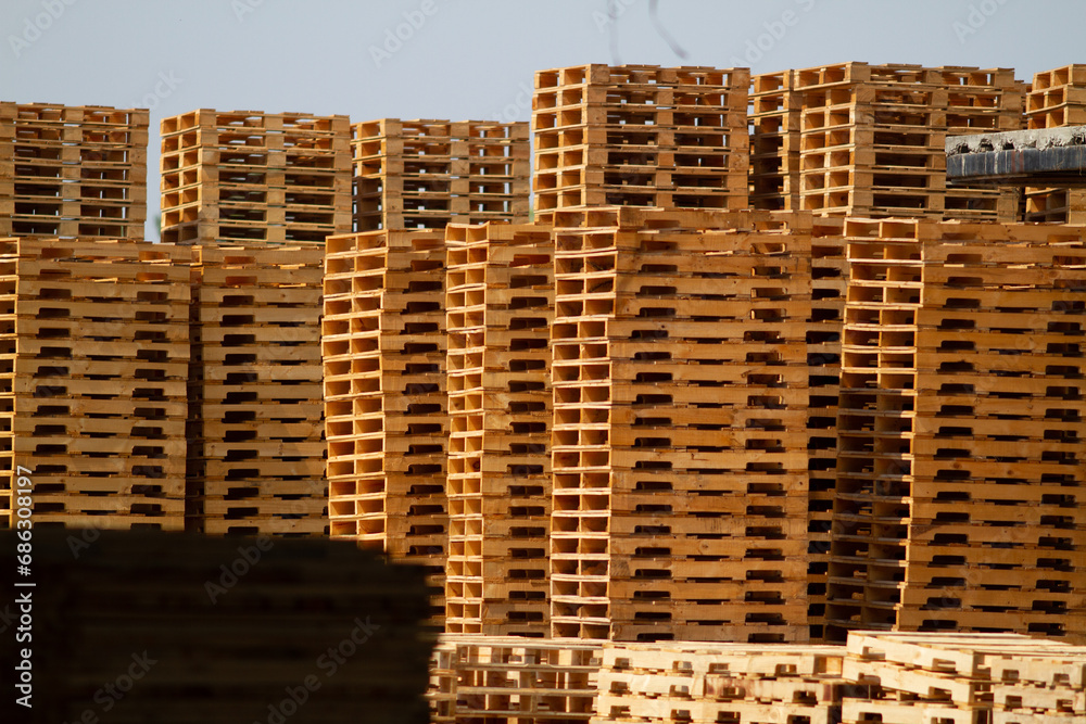 a large outdoor storage facility at a lumber mill where raw wood material is transformed and milled into wooden agriculture shipping pallets for worldwide distribution vis shipping containers a large outdoor storage facility at a lumber mill where raw wood material is transformed and milled into wooden agriculture shipping pallets for worldwide distribution vis shipping containers