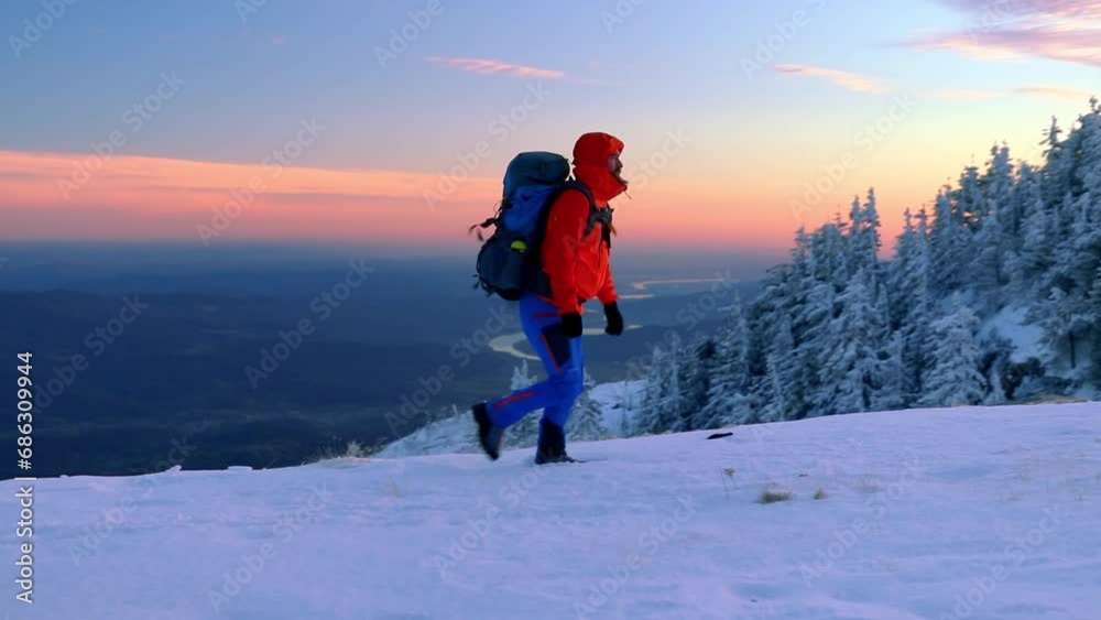 Amazing winter landscape with alone hiker walks on snow in the mountain Amazing winter landscape with alone hiker walks on snow in the mountain