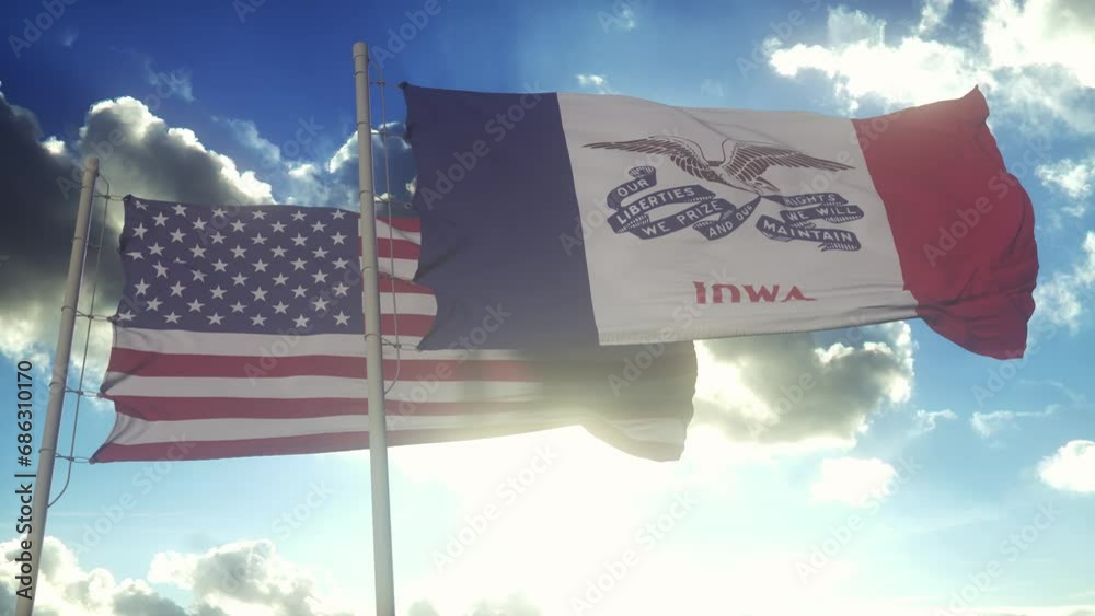 The Iowa state flags waving along with the national flag of the United States of America. In the background there is a clear sky
