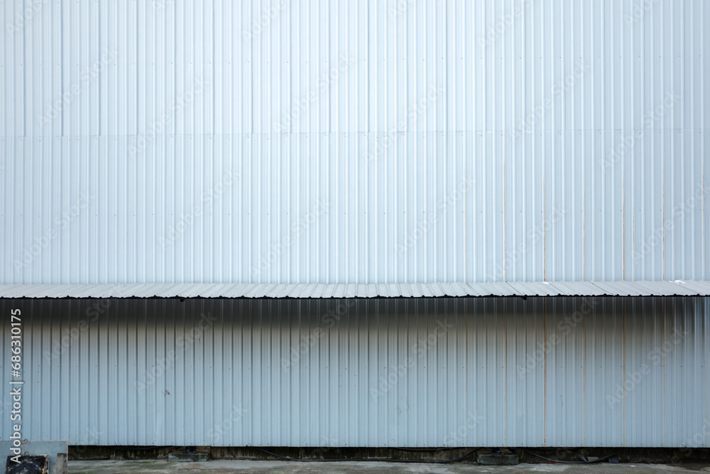 Textured Corrugated Metal Siding on Industrial Building Facade of temporary construction site. Textured Corrugated Metal Siding on Industrial Building Facade of temporary construction site.