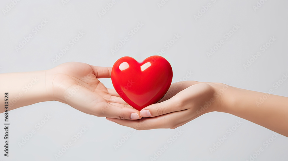 A man gives a woman a red heart on a white background
A man gives a woman a red heart on a white background
