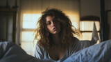 Young teenage sitting on her bed with messy hair, wake up in the morning after healthy sleep, closeup portrait