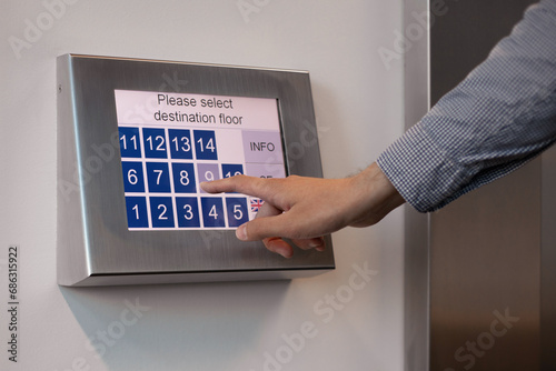 Male hand pressing lift buttons in business centre