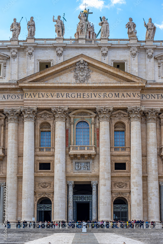 symmetrically framed front and central facade of the basilica of st peter in the vatican with details of the columns and windows