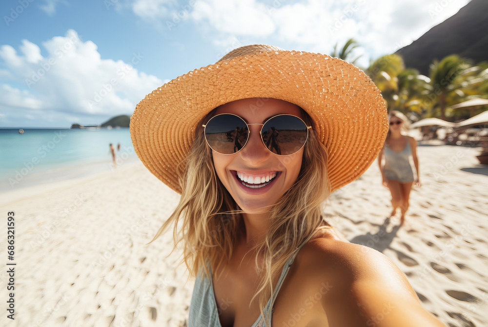 Happy smiling girl in hat taking selfie on tropical beach