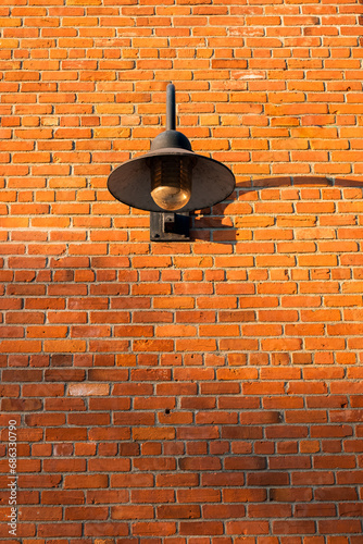 Vintage old street lantern with on a brick wall. Wall street light. Old style lantern photo