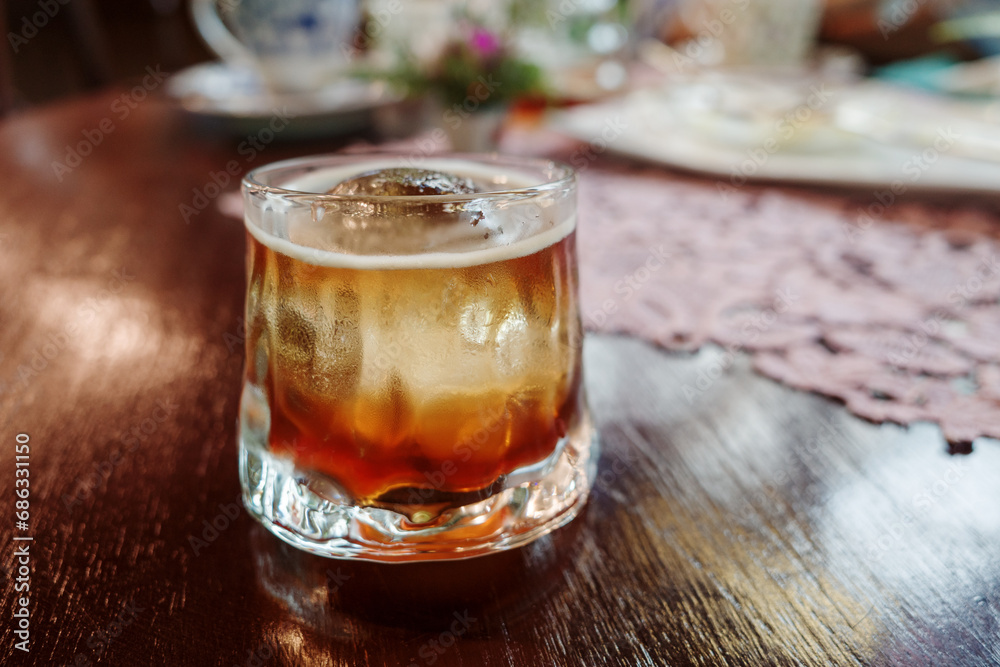 Chilled cold brew coffee on a Rustic Wooden Table Chilled cold brew coffee on a Rustic Wooden Table