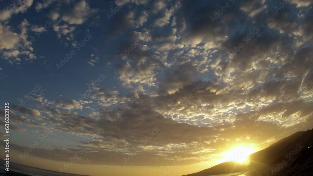 Timelapse Lockdown Of Billowing White Clouds Passing Overhead Over A Beach At Sunset - Malibu, California Timelapse Lockdown Of Billowing White Clouds Passing Overhead Over A Beach At Sunset - Malibu, California