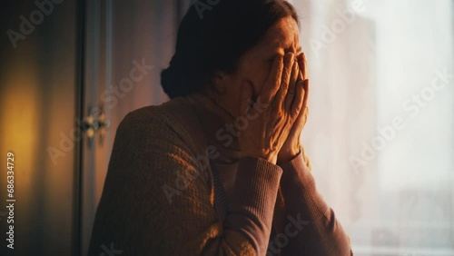 Depressed senior woman crying after receiving bad news, expensive bills, poverty photo