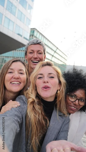 Vertical. Group of real successful business woman smiling and having a video call conference. Teamwork of females waving hands and looking at camera. Happy startup executive ladies laughing at work