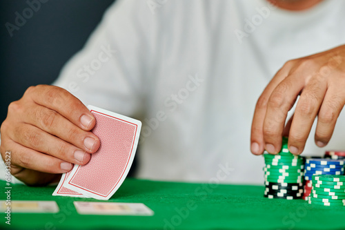 Closeup of man with pair of cards in poker