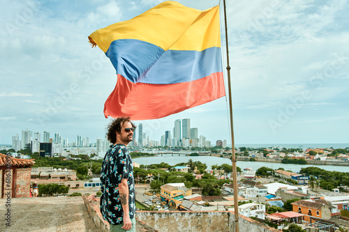 Man next to the flag of Colombia with Cartagena de Indias photo