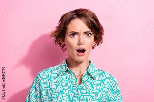Portrait of impressed speechless young girl open mouth staring cant believe isolated on pink background photo