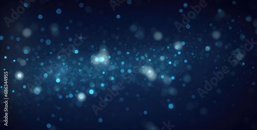 Dark blue bokeh background with sparkling star dust particles in motion, contemporary glitter opulent golden sparkles. Blurred, defocused, abstract background for Christmas.