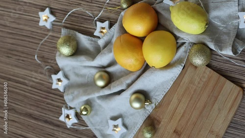 New Year's layout of oranges, board, napkins, garlands and balloons on the kitchen table.Preparations for the holiday.Preparing for the celebration of Christmas.The concept of a cozy kitchen