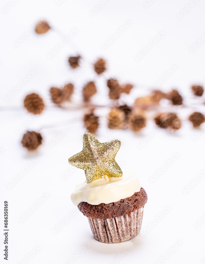 ginger bread cup cake with frosting and star shaped decoration isoalted on white in studio