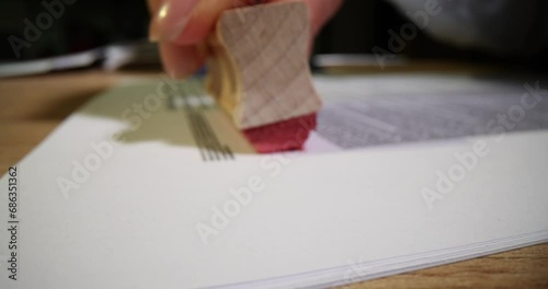 Closeup of person hand stamp with rejected stamp on text of rejected document on form and contract table photo