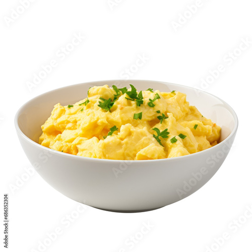 Creamy scrambled eggs garnished with chives on a white dish. photo