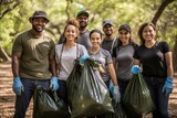 Portrait of volunteers carrying garbage bags in park on a sunny day