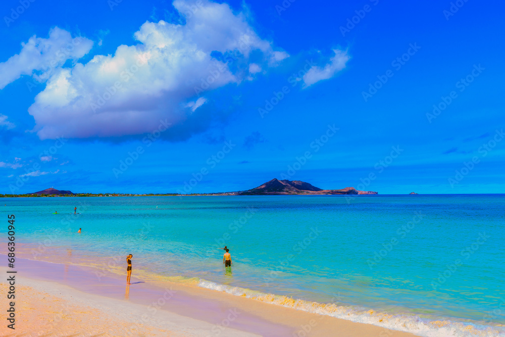 Crystal clear ocean water at Waimanalo Beach, Oahu, with island view.