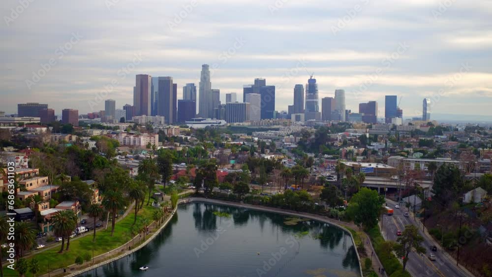 Aerial Shot Of Modern Buildings In Financial District Amidst Residential Houses, Drone Flying Forward Over Lake In Famous Park - Los Angeles, California Aerial Shot Of Modern Buildings In Financial District Amidst Residential Houses, Drone Flying Forward Over Lake In Famous Park - Los Angeles, California