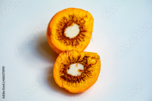 Ripe Pequi fruit (Caryocar brasiliense), showing the dangerous thorns in detail inside the ripe fruit. Dangerous food fruit photo