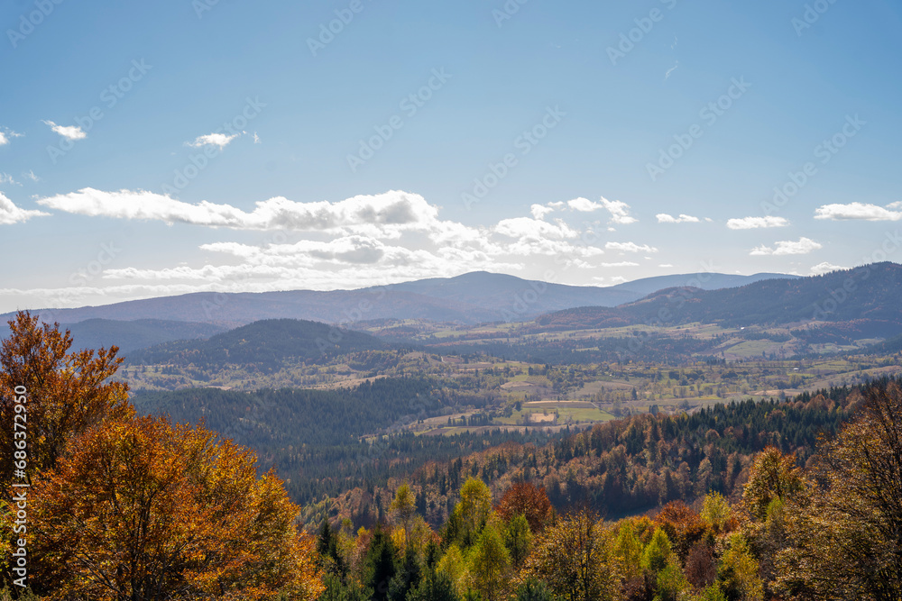 Idyllic fall landscape with gloomy mountain tops on the horizon captured from a hill of mountain Golija