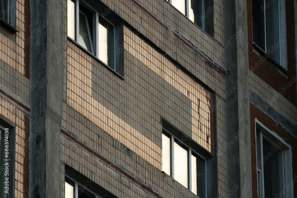 A fragment of a prefabricated reinforced concrete multi-apartment multi-storey building lined with ceramic tiles.