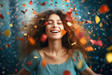Happy smiling young woman standing under falling confetti