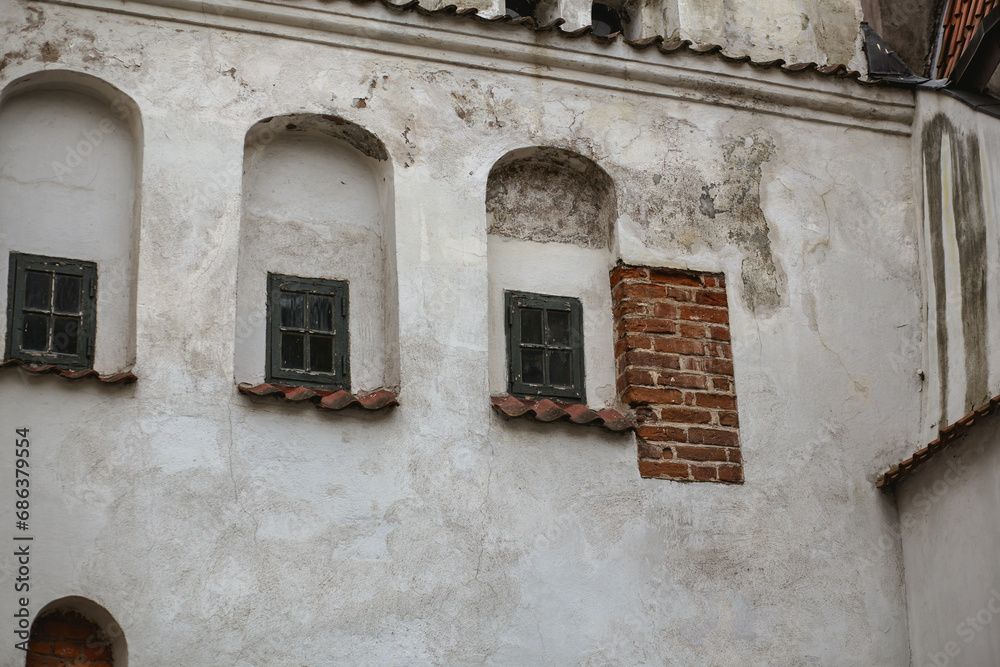 Old tiny wooden windows in an old building facade in Riga