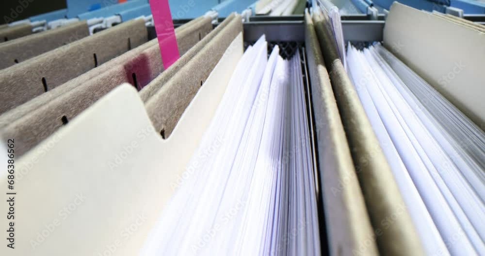 Organize personal document files in filing cabinet drawer