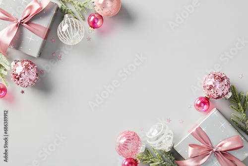 Modern Christmas background with gift boxes, ball decorations, fir branches. Flat lay, top view.