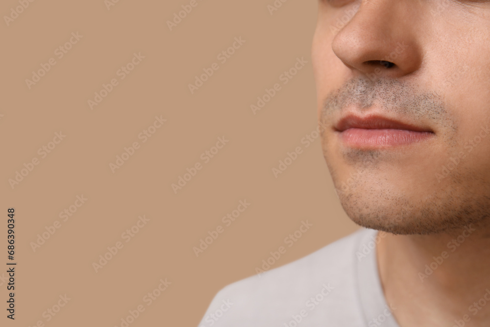 Fototapeta premium Ill young man on brown background, closeup