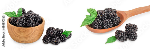 blackberry with leaf in wooden bowl and spoon isolated on a white background.