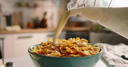 Wallpaper Mural Unknown pours milk over breakfast cereal at beautifully decorated table modern kitchen. Advertising cinematic slow motion. Beautiful calm dream breakfast on cozy sunny morning. Healthy nutrition food Torontodigital.ca