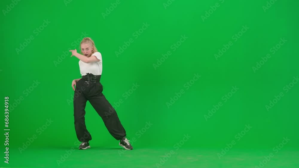 In the frame on a green background, chromakey. A young, slender, beautiful girl is dancing. She demonstrates various dance moves in the direction of jazz funk. She is rhythmic, plastic. General plan In the frame on a green background, chromakey. A young, slender, beautiful girl is dancing. She demonstrates various dance moves in the direction of jazz funk. She is rhythmic, plastic. General plan