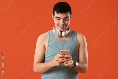 Young man in tank top and h...