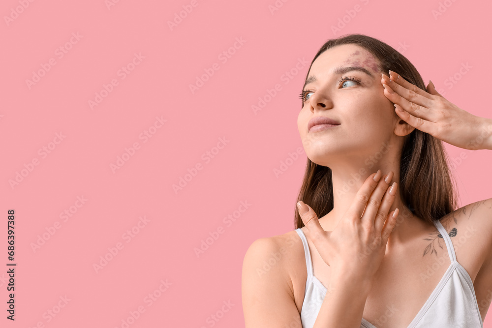 Young woman doing face building exercise on pink background, closeup Young woman doing face building exercise on pink background, closeup