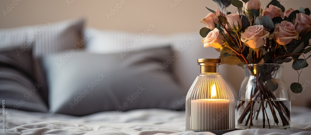 On Valentine s Day morning there s a luxurious scent emanating from a reed diffuser on the gray table in the bedroom next to a scented candle and the gray bed On Valentine s Day morning there s a luxurious scent emanating from a reed diffuser on the gray table in the bedroom next to a scented candle and the gray bed