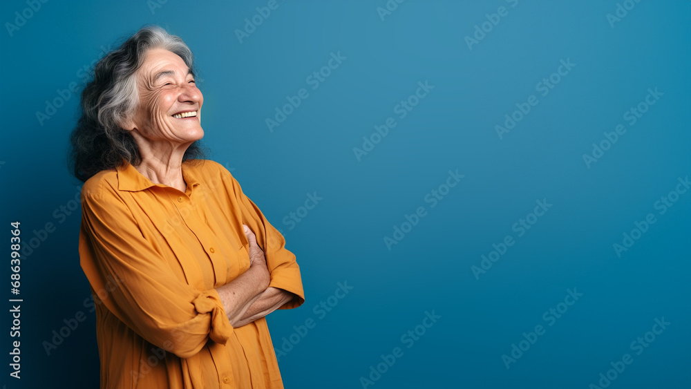 funny elderly woman smiling laughing out loud against blue background funny elderly woman smiling laughing out loud against blue background