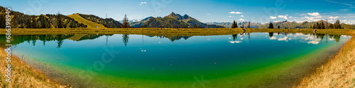 High resolution stitched alpine summer panorama with reflections at Lake Spiegelsee, Mount Fulseck, Dorfgastein, St. Johann im Pongau, Salzburg, Austria photo