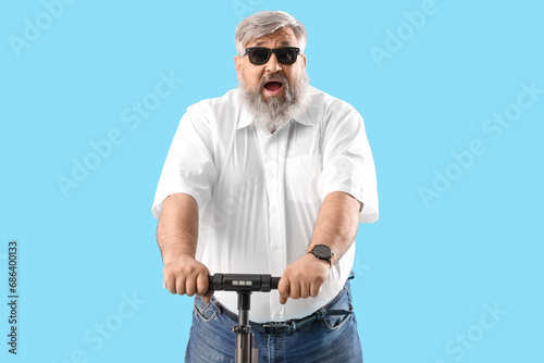 Shocked mature man riding e...