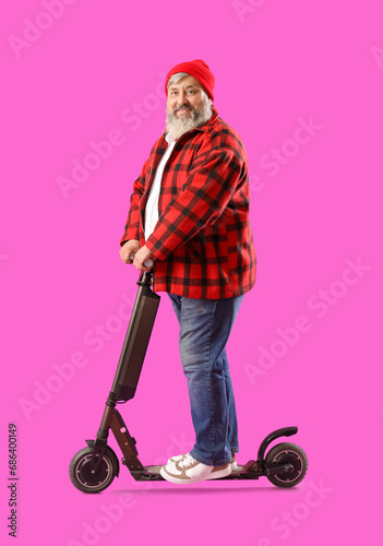 Mature man riding electric ...