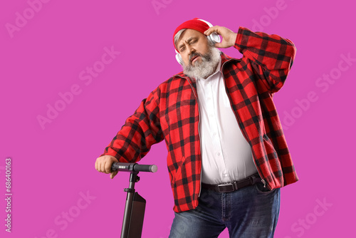 Mature man in headphones wi...